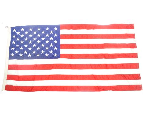 An original large vintage likely 1970s period United States American Flag. The seam with maker's marks and details for the Va