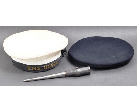 A collection of assorted WWII Second World War and later Royal Navy officers uniform caps and marlin spike tool. The caps to 