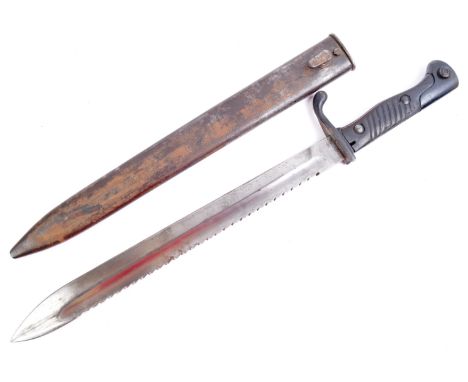 An original WWI First World War Imperial German Army ' Butcher ' sawback bayonet and steel scabbard. The single-edged saw bac