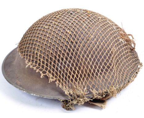 An original WWII Second World War British Army steel combat Brodie helmet. Complete example, with liner (dated 1942) and chin