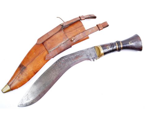 An original WWI First World War Gurkha Regiment Kukri knife and scabbard. The knife having a shaped mahogany and brass bound 