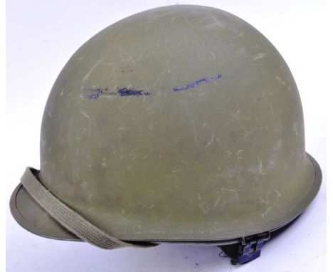 An original post WWII Second World War US United States Army M1 steel combat helmet.&nbsp;The helmet having a green painted s