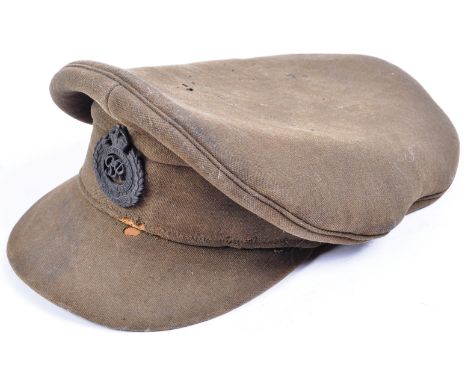 An original WWI First World War period British Army uniform Officers' ' crusher ' cap. The peaked cap complete with George VI