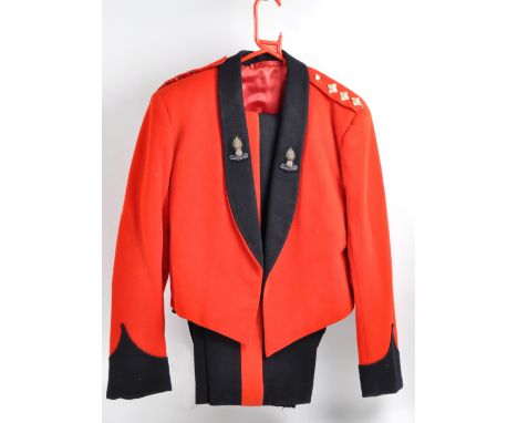 A 20th Century British Army Royal Engineers Captains mess uniform comprising a scarlet jacket and black trousers with scarlet