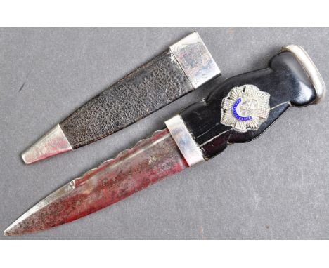 A 20th Century Royal Scots ' Sgian-Dubh ' dress dagger of Boer War interest. The traditional knife having a white metal pomme