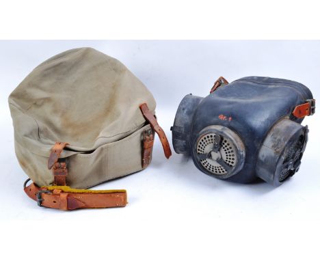 A rare WWII Second World War Third Reich Nazi German horse respirator gas mask. The mask having a large black rubber shield f