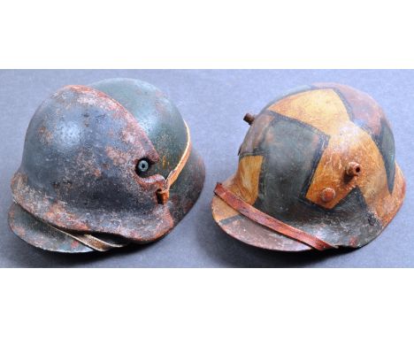 Two WWI First World War replica miniature M16 pattern German Army helmets - the first an M16 camouflage helmet, and the secon