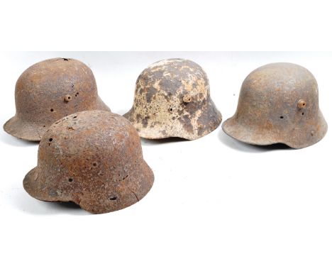 A collection of x4 original WWI First and WWII Second World War German army Stahlhelm steel combat helmets. All in relic cond