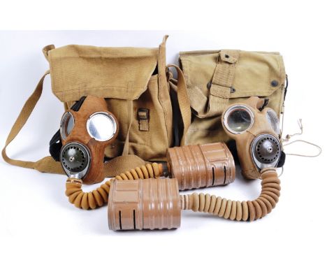 Two original WWII Second World War British Army respirator gas masks with canisters and canvas haversacks. The gas masks of u