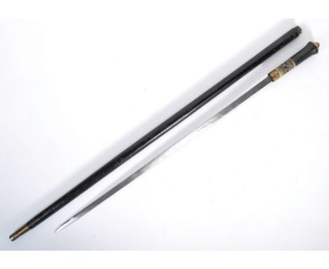 A late 19th Century Indian gentleman's sword stick / walking cane with concealed blade. The cane having a brass pommel engrav