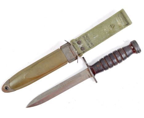 An original 20th Century US United States Military M4 rifle bayonet housed within an M8 scabbard. The knife having a flat ste