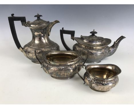 An Edwardian silver four-piece tea service, of Georgian shape, with lobed and gadrooned decoration, the tea pot bearing an en