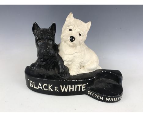 A Brentleigh Ware painted plaster Black & White Scotch Whisky advertising stand and a similar figurine, second quarter 20th C