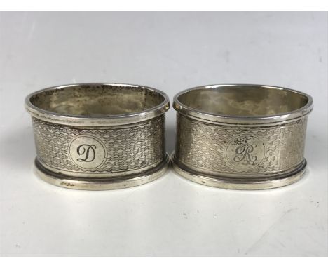 A pair of George V silver napkin rings, of oval section, having engine turned decoration, TS, Birmingham, 1933, 30.4g