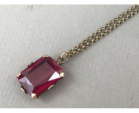 A contemporary Verneuil ruby pendant necklace, the cushion-cut stone of approximately 16 x 12 mm, claw and rope-twist set in 