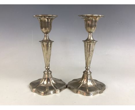 A pair of Edwardian silver candlesticks, each engraved with the initial 'K', Hawksworth, Eyre &amp; Co Ltd, Sheffield, 1902, 
