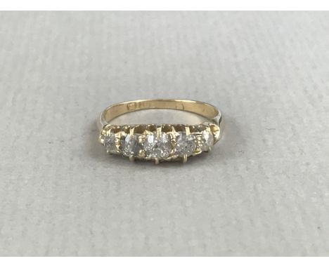 A vintage five-stone diamond ring, having a central cushion-cut stone of approximately .25ct, on a high-carat yellow-metal sh