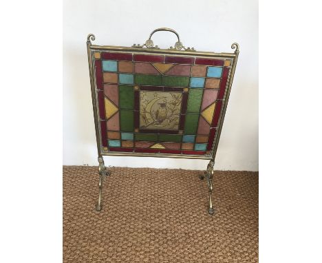 A late Victorian Aesthetic movement stained-glass and brass fire screen, the central hand-enamelled pane depicting an owl and
