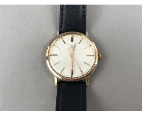 A gentleman's Omega rolled-gold wristwatch, having manual wind movement, champagne face and baton markers
