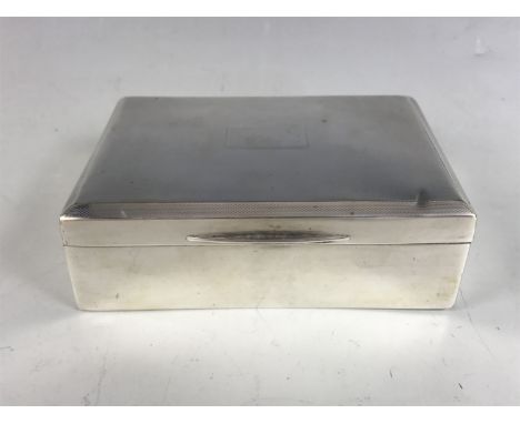 A George VI silver table cigarette box, decorated overall with fine engine turning, the lid having canted edges and centred b