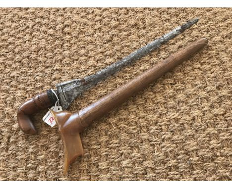 An antique Malayan kris dagger, having characteristic carved stylized bird form handle and subtle pamor to the blade, in wook