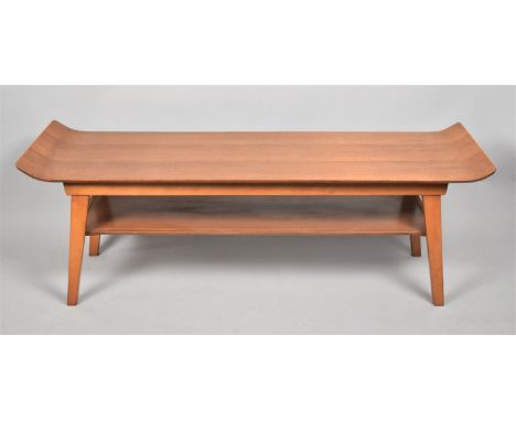 A 1970's "Surfboard" Coffee Table in Teak with Raised Ends and Stretcher Shelf, 112cm Long 