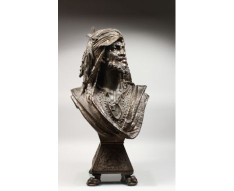 A SUPERB METAL BUST OF AN ARAB with moustache and beard, headdress and cloak, on a square base with claw feet. 30ins high.