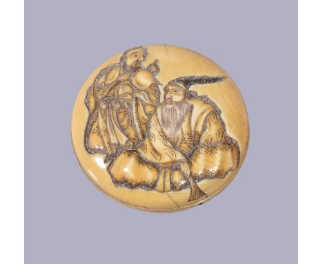 ϒKosai: A Japanese Ivory Manju Netsuke, in two parts, carved in deep shishiaibori on the top with a seated sage holding a fan