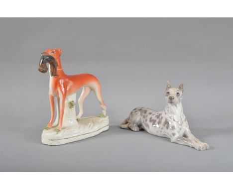 A 19th century Staffordshire dog, a hunting dog with a rabbit in its mouth, some restoration to the ear and a hairline throug