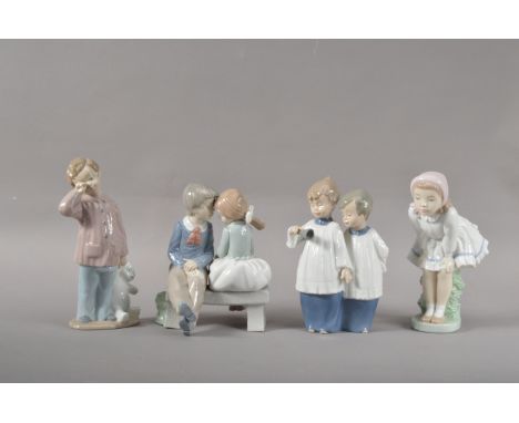 Four Nao porcelain figurines,  comprising two figural groups of children, one two choir boys 18cm high, and a girl and sleepy