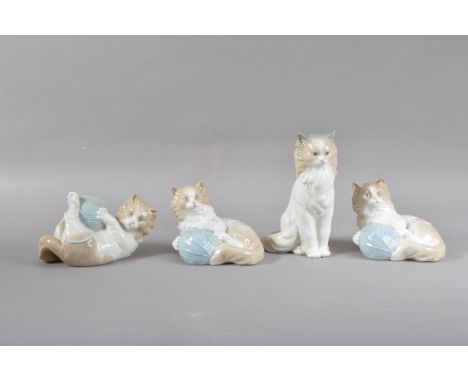 Four Nao porcelain cat figurines, three with balls of twine, all marked to the undersides, the tallest 18cm (4) 