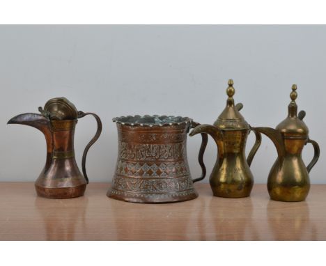 A collection of Middle Eastern antique brass and copper wares, comprising two brass handled jugs with covers, of slightly dif