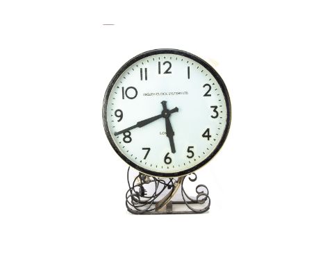 English Clock Systems Train Station Platform Clock, a circular metal cased single sided clock mounted on a wrought iron brack