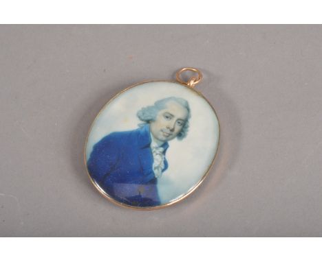 An 18th Century oval portrait miniature on ivory in gold frame, with pendant bale, depicting a 3/4 length portrait of a gentl