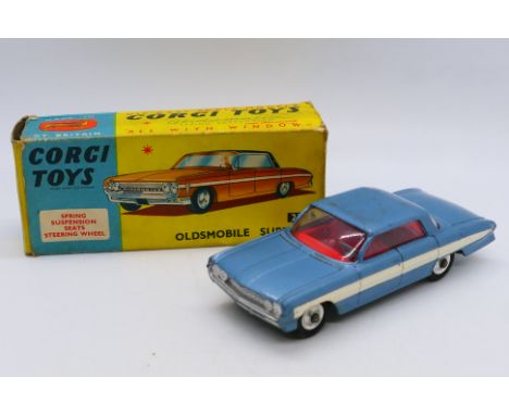 Corgi - A boxed Oldsmobile Super 88 sedan in light blue # 235. It shows signs of use and appears in Fair to Good condition in