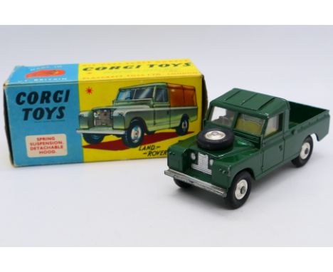 Corgi - A boxed Land Rover 109 Pickup in dark green # 438. The model shows some signs of use and appears in Good condition, i