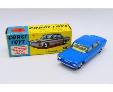 Corgi - A boxed Chevrolet Corvair sedan in mid blue # 229. The model appears Near Mint with only a few minor marks on raised 