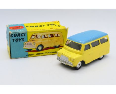 Corgi - A Bedford CA Dormobile in yellow with a blue roof # 404. The model shows some signs of use and appears in Good condit