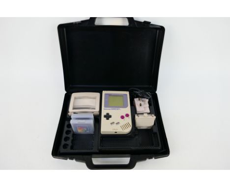 Nintendo - Gameboy. An LMP Gamester case (black) containing a Nintendo Gameboy v1 with Magnifier / light accessory, official 