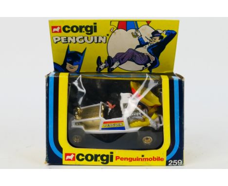 Corgi - A boxed Corgi #259 'Penguinmobile' The model in white with Penguin figure, gold wheels, gold wheels has a broken red 