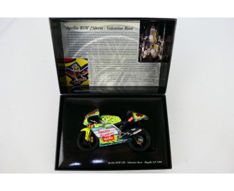 Minichamps - A boxed 1:12 scale Valentino Rossi Aprilia RSW 250ccm 1999 Mugello GP bike # 12299046. The model appears Mint, t