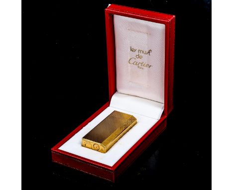 CARTIER - a Vintage gold plated Les Must De Cartier gas lighter, engine turned decoration, serial no. 80059K, length 6cm, box