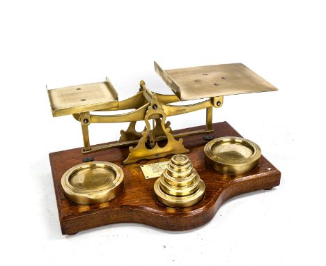 A set of large Victorian brass postal balance scales and weights, on oak base, width 38cm 