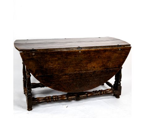 A large 17th/18th century oak gateleg dining table, on ring-turned legs with two frieze drawers, extended top 170cm x 145cm, 