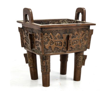 A Chinese Archaic style patinated bronze incense burner, with relief moulded sides, length 15cm 