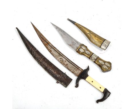 A Middle Eastern dagger with ivory grips, and a Chinese brass and white metal-mounted dagger and scabbard (2) 