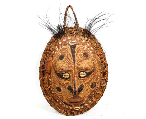 A South Seas turtle shell and wicker wall-hanging Tribal mask ornament, with applied shells and painted decoration, height ex