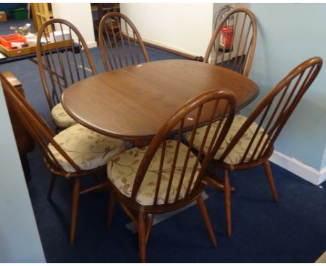 An Ercol dining table and six chairs.