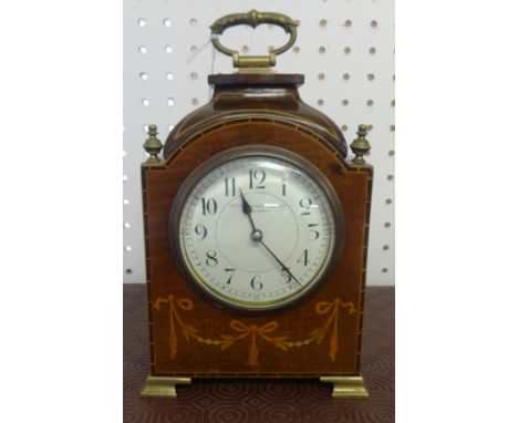 A mantle clock with French drum movement, in an inlaid and mahogany case, the dial inscribed 'Sussex Goldsmith , Brighton'.