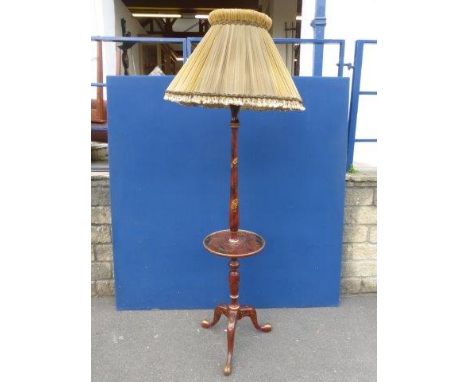 An Edwardian chinnoiserie decorated and red lacquered standard lamp with period pleated shade and wide circular shelf. 